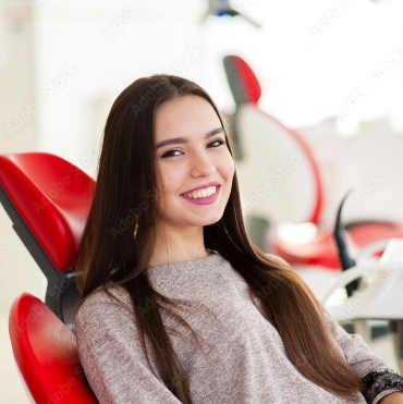 Tummarello & Pandak <br>Family Dentistry smiling young lady on a dentist chair