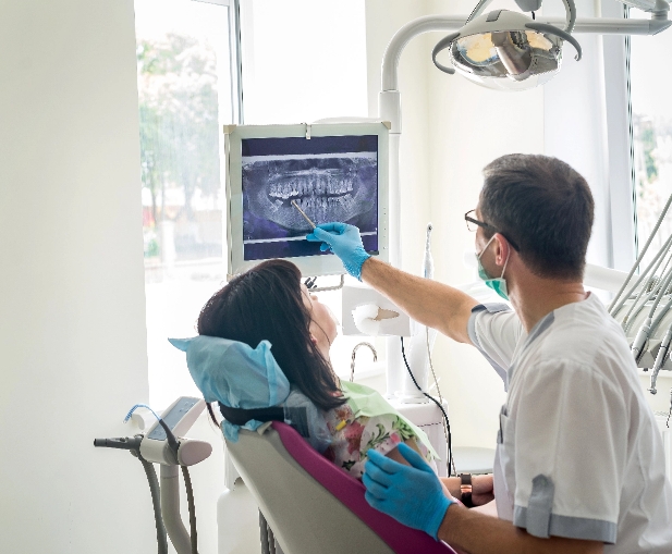 Tummarello & Pandak <br>Family Dentistry experienced doctor showing an exray